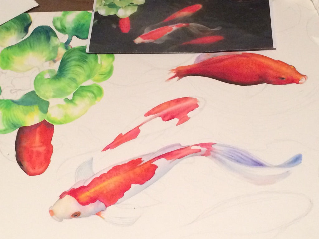 Coy Koi watercolor in progress showing warm orange koi and lily pads before the deep blue water and gemstone glazing were added.

