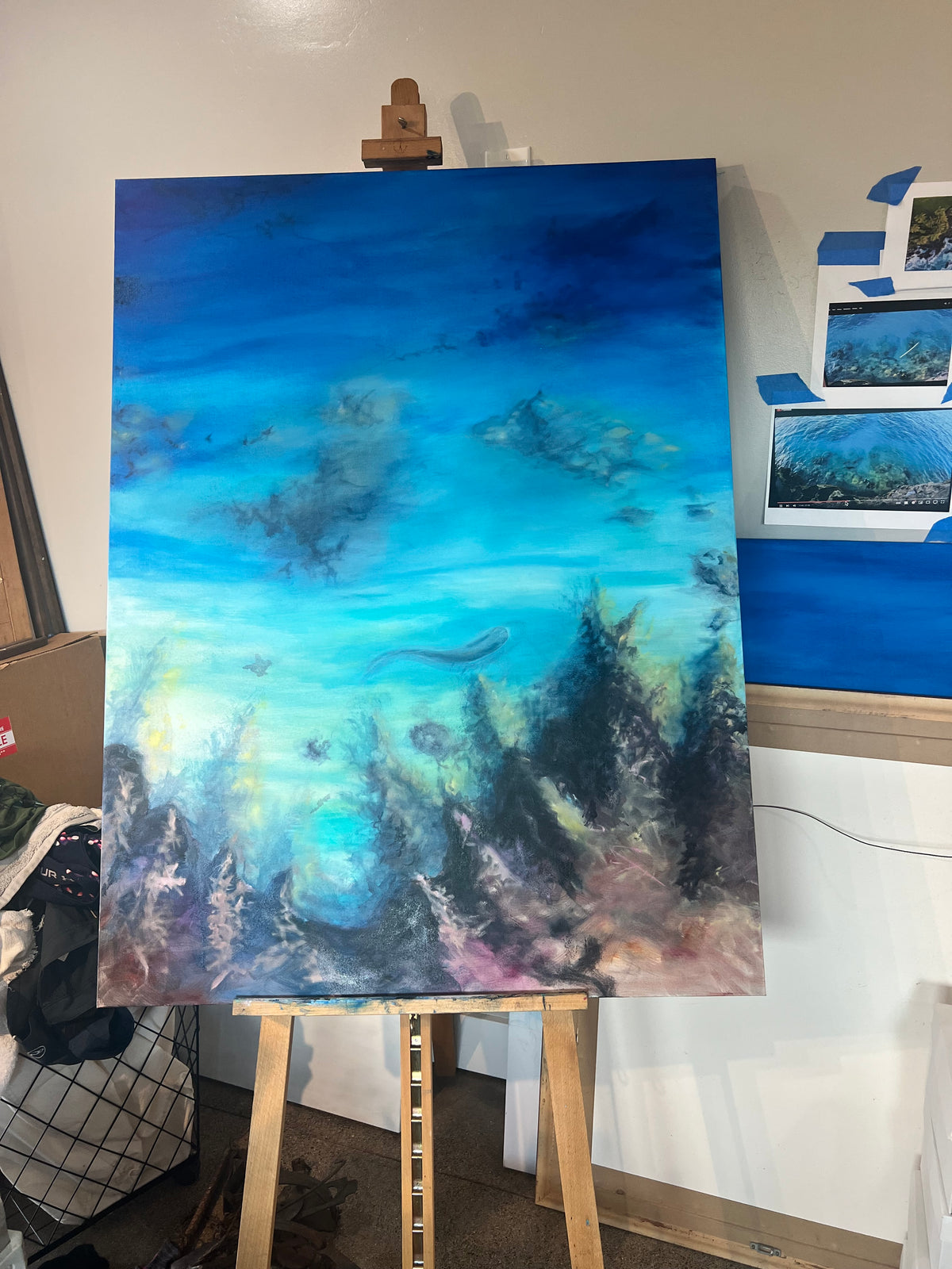 Nalu me nā Nalu oil painting in progress showing early layers of ocean depth and underwater shadows