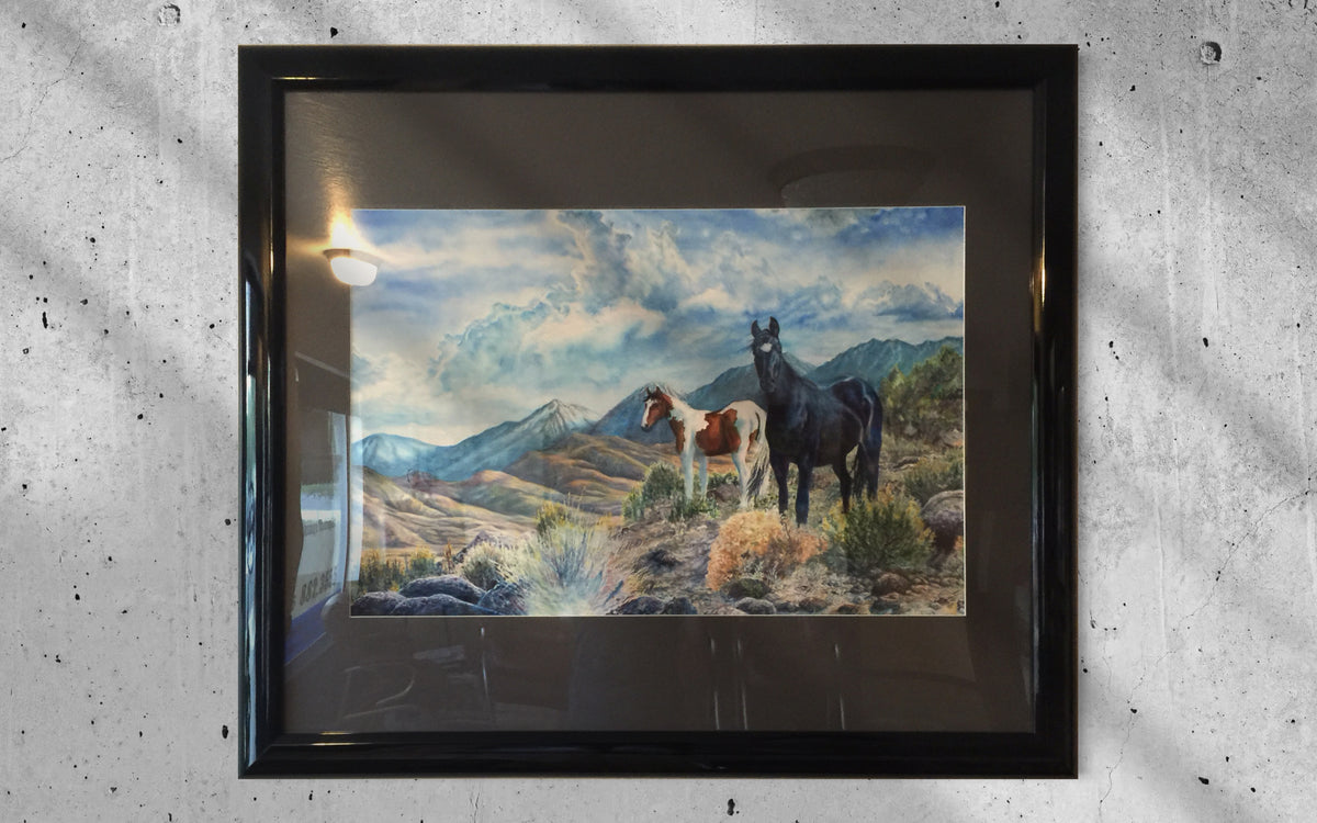 Mustangs Wild professionally framed in glossy black with dark gray matting and Plexiglas glazing
