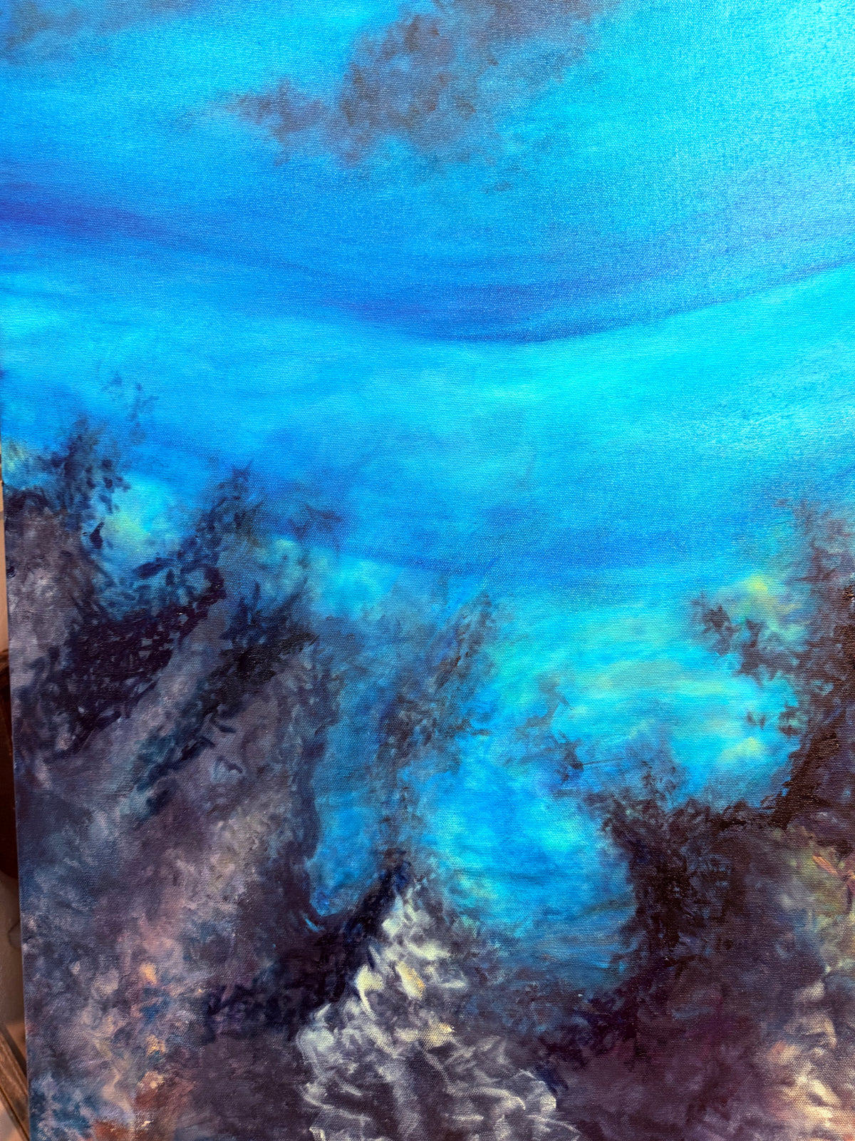 Detail of underwater shadows depth and volcanic coastline beneath the waves in Nalu me nā Nalu
