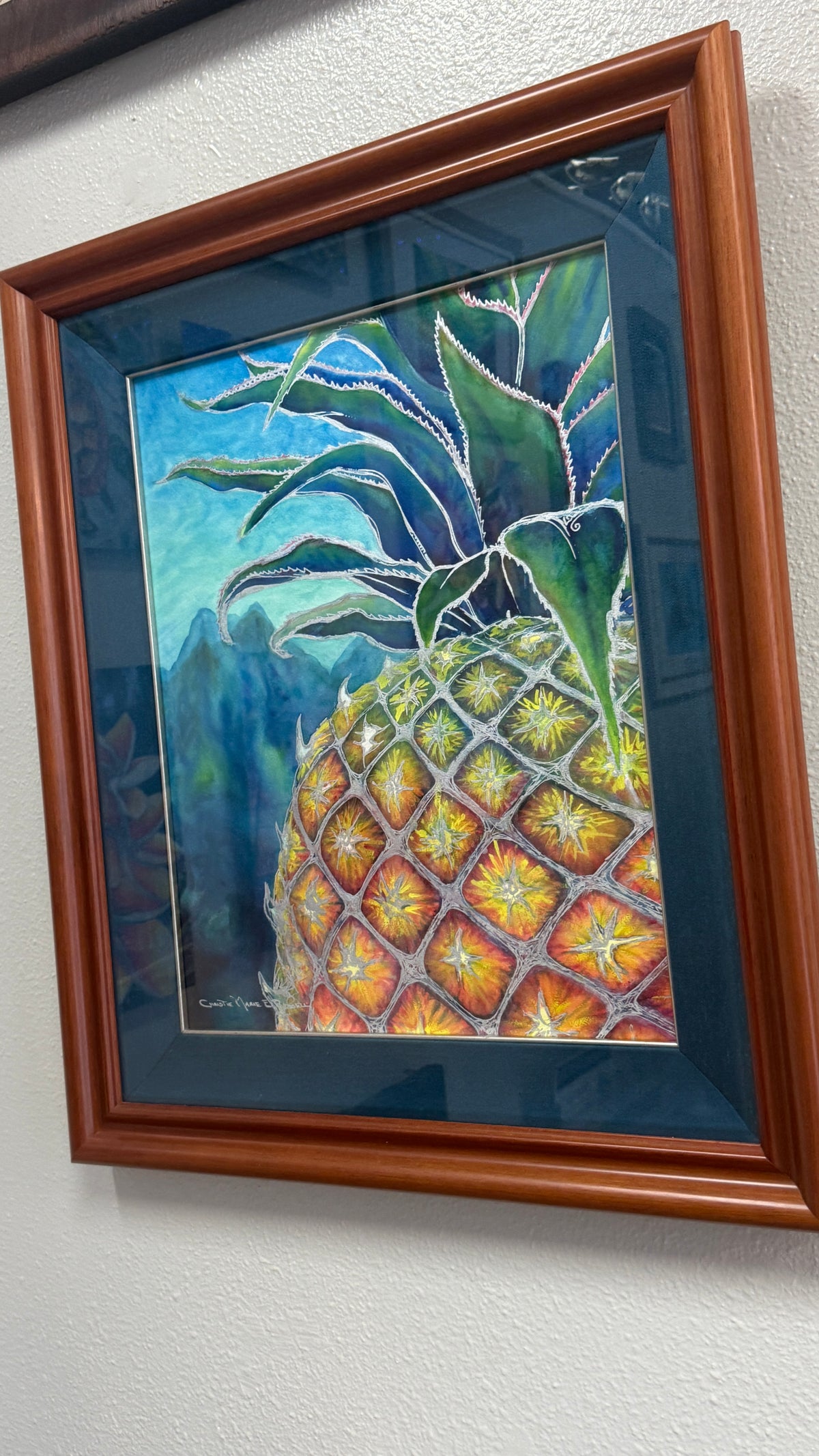 Sweet Welcome by Christie Marie Elder is an original tropical pineapple watercolor with metallic silver detailing, professionally framed and one of one angle perspective in gallery.