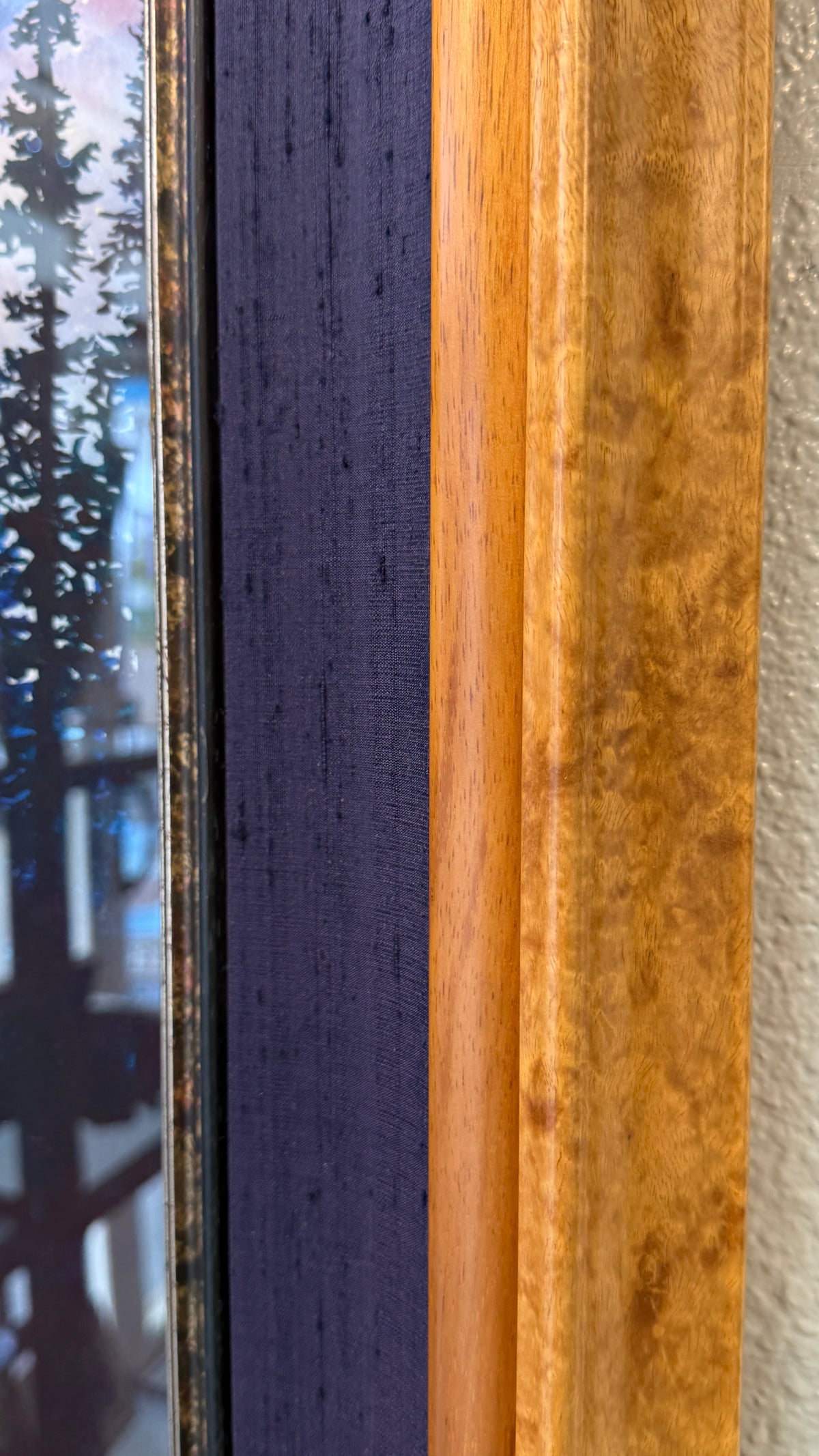 Close-up of burl-patterned wood midnight-blue silk and antiqued metallic framing on Spirit Fox
