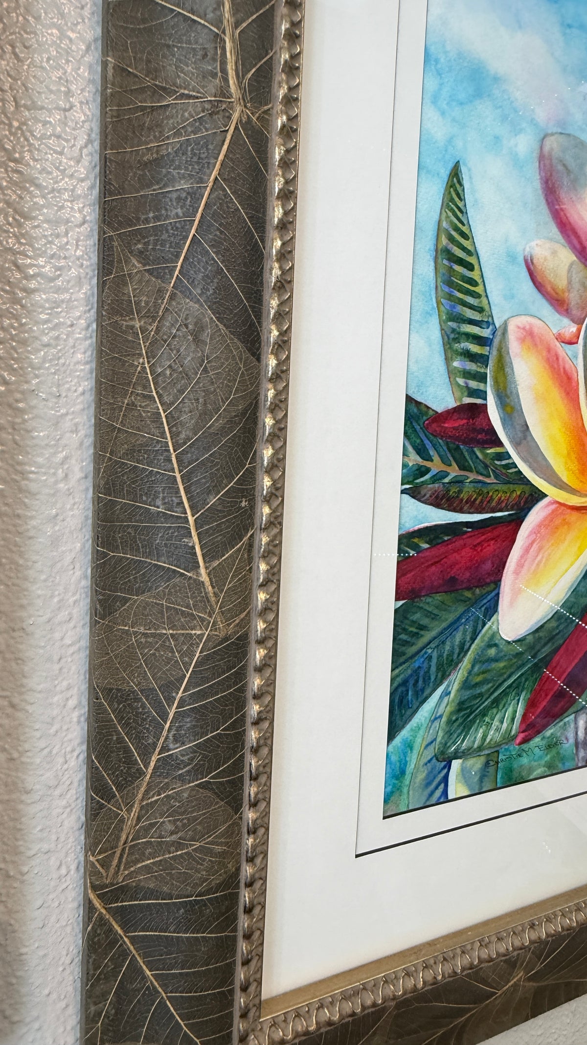 Close-up of the richly textured frame with real leaves and warm metallic detailing on Laʻa Kea o Kekaha
