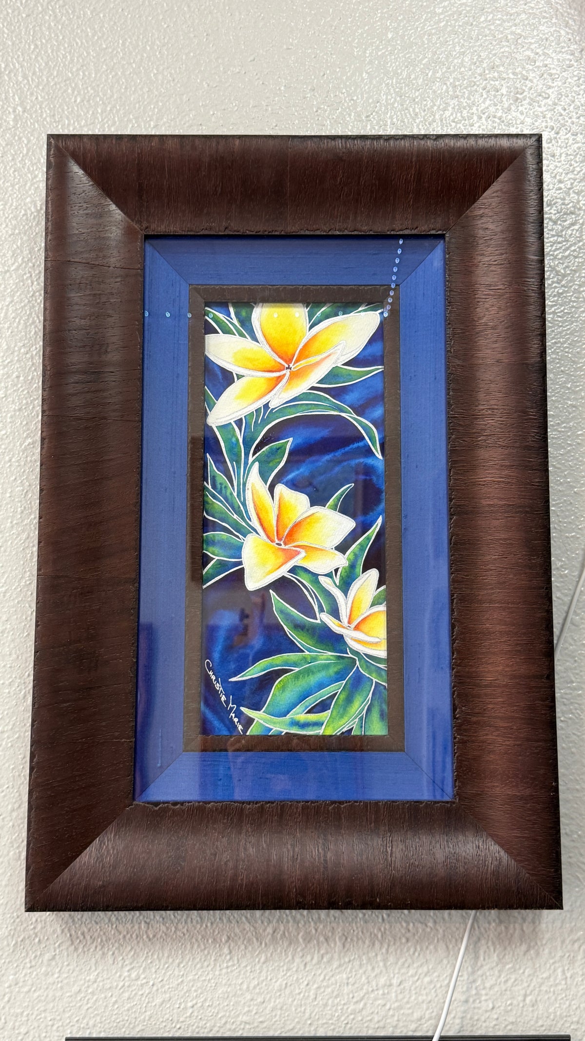 Wedding Lei shown in its included custom professional frame with rich blue silk liner and substantial dark wood molding.