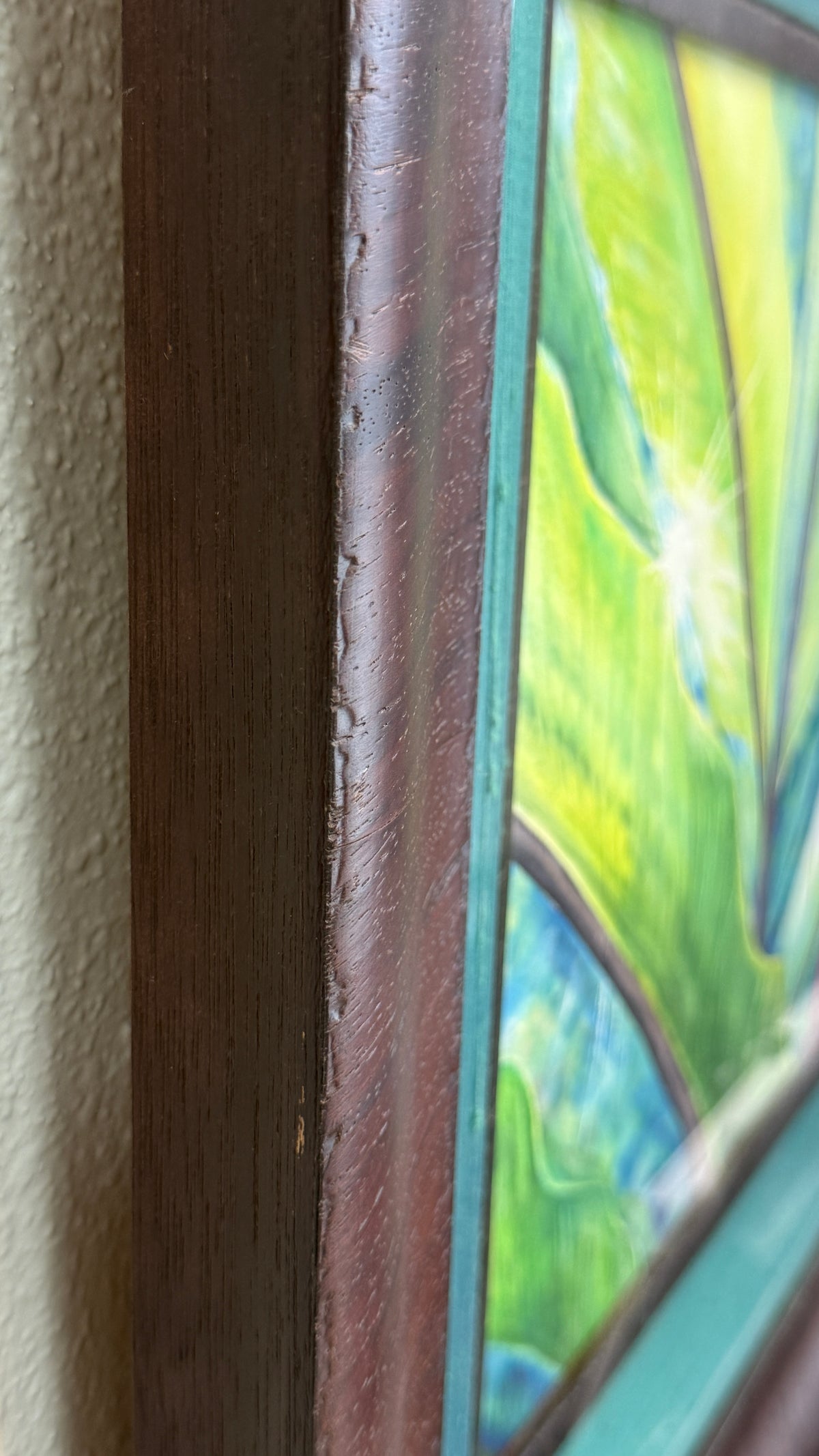 Close-up of the dark wood frame and turquoise silk-wrapped liner surrounding Tropical Flame deep one and a half inch frame.