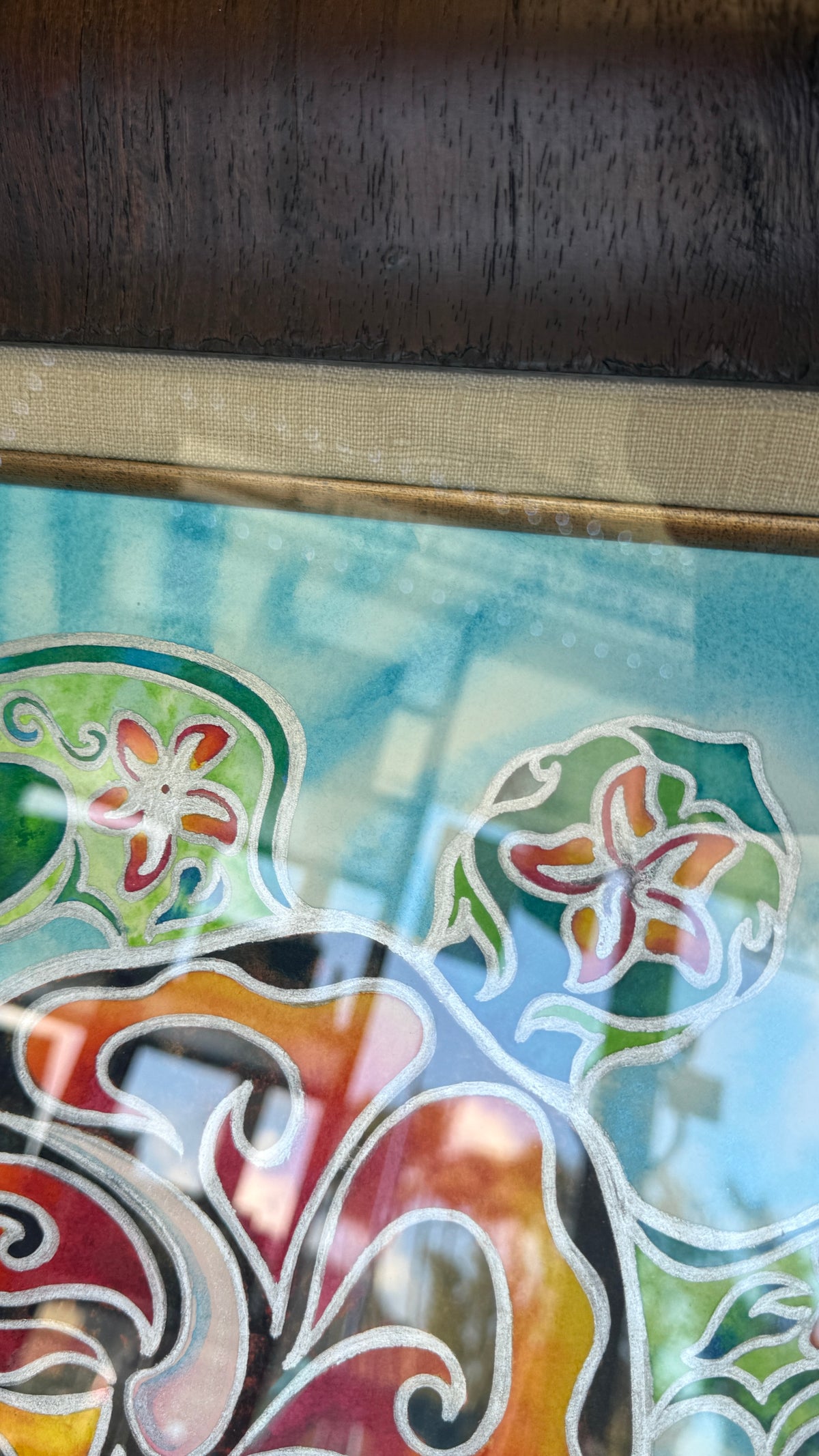 
Close-up of Nani Honu showing reflective silver details beside the woven taupe frame liner and gold-toned fillet