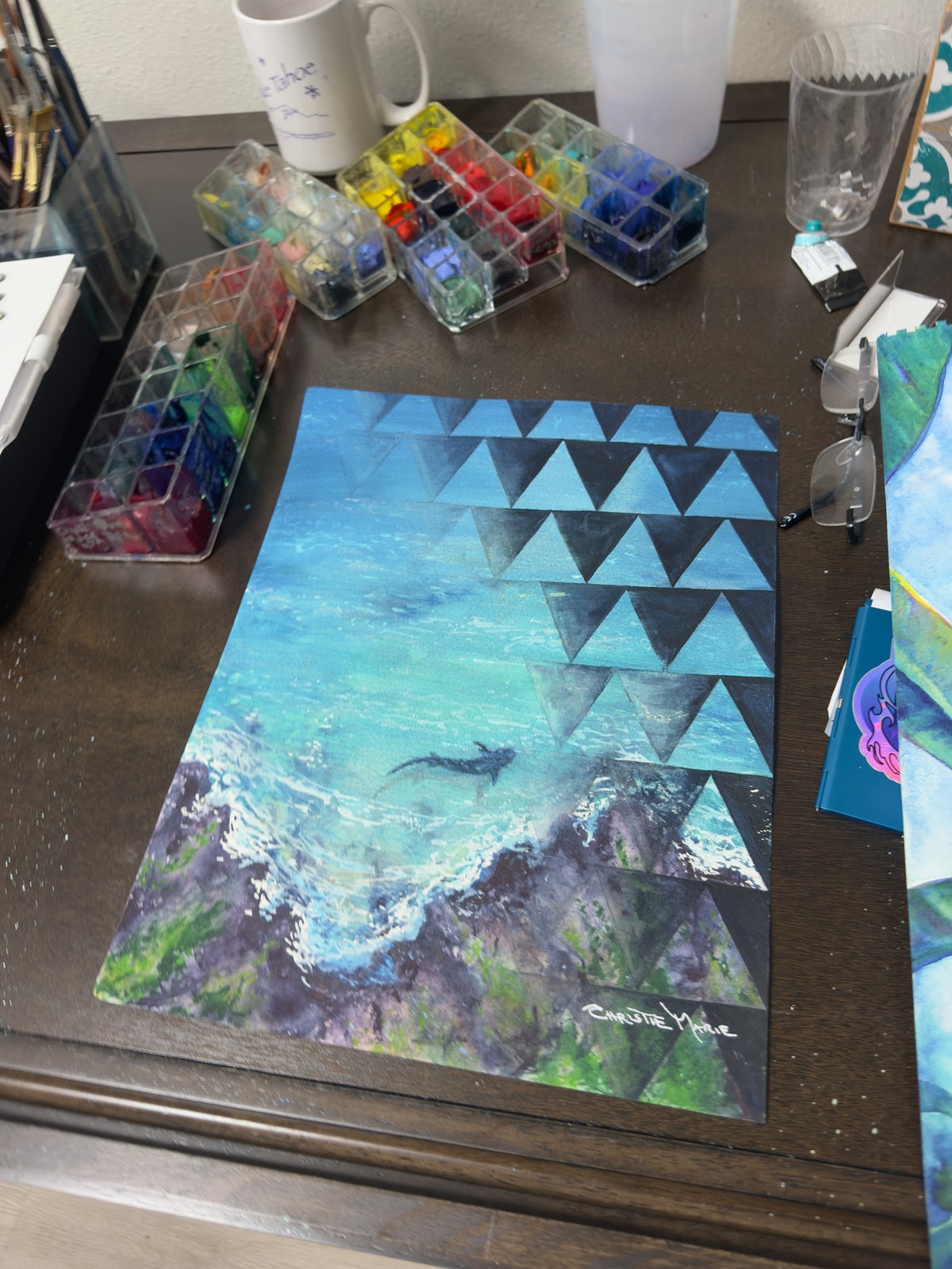 Mano Niho original watercolor in Christie Marie Elder’s studio surrounded by watercolor paints and working materials