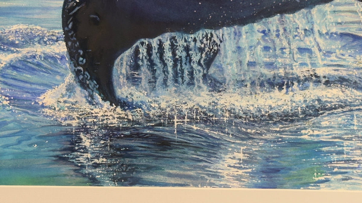 A close-up of original watercolor painting of a whale tail and  ocean water, with blue and white splashing water and a dark whale body visible above the surface.