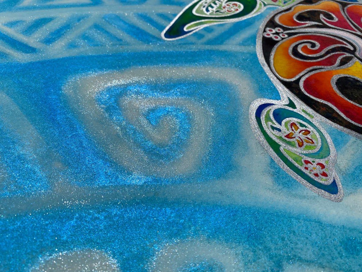 
Close-up of Nani Honu showing reflective blue gemstone watercolor and swirling water patterns