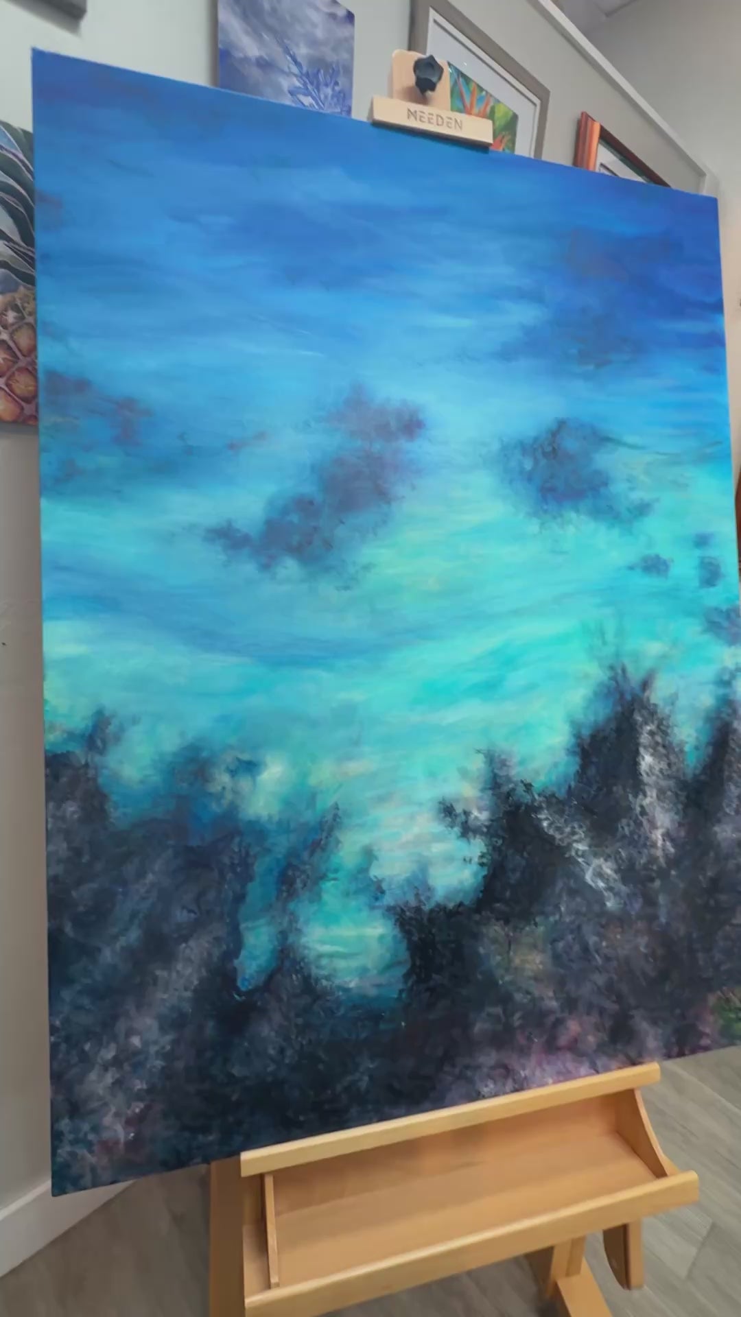 Video of Christie painting in detail into the submerged layer of lava and coral below on the ocean floor.